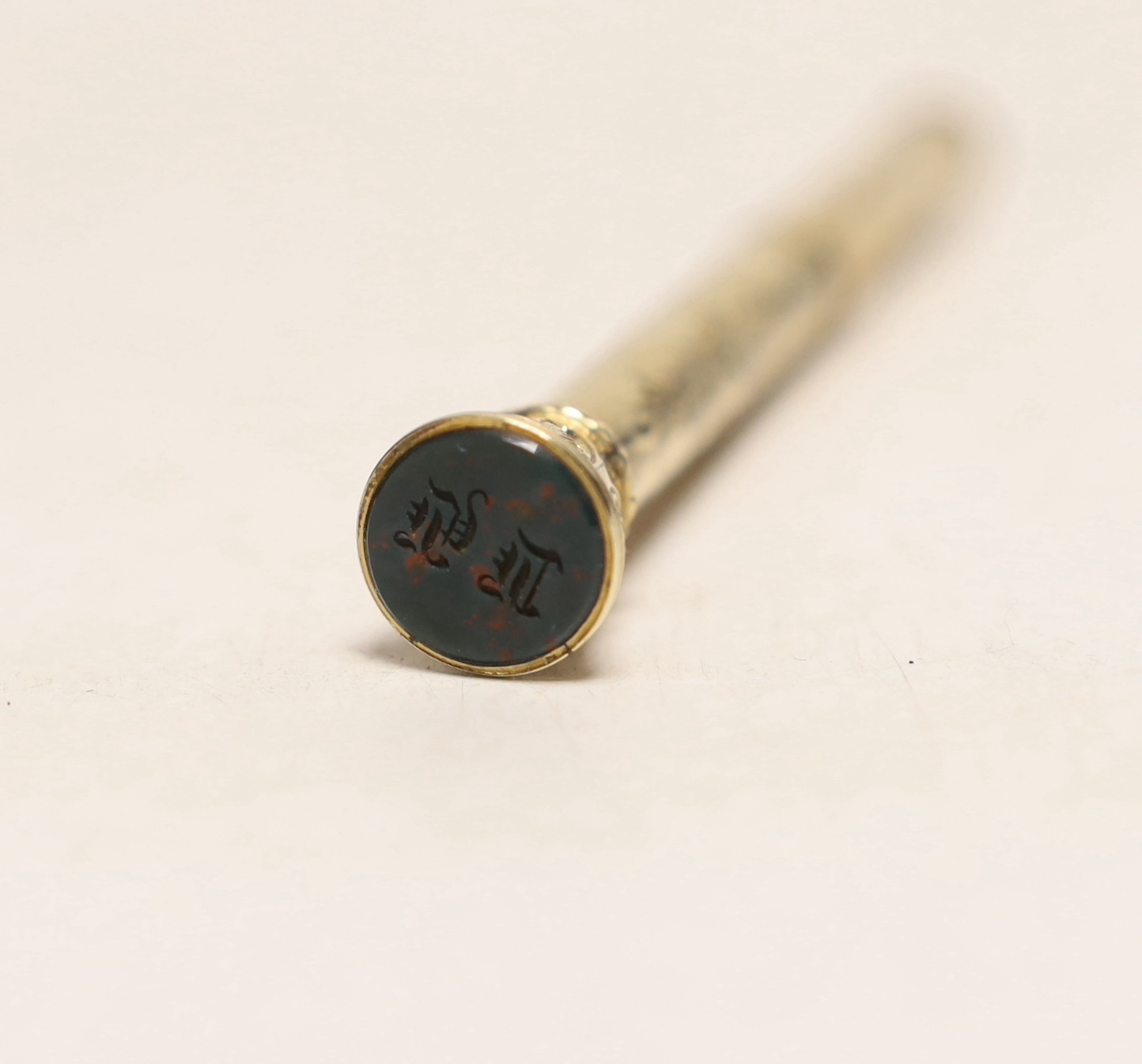 A late Victorian engraved yellow metal overlaid propelling pen and pencil, with bloodstone set terminal, 95mm.